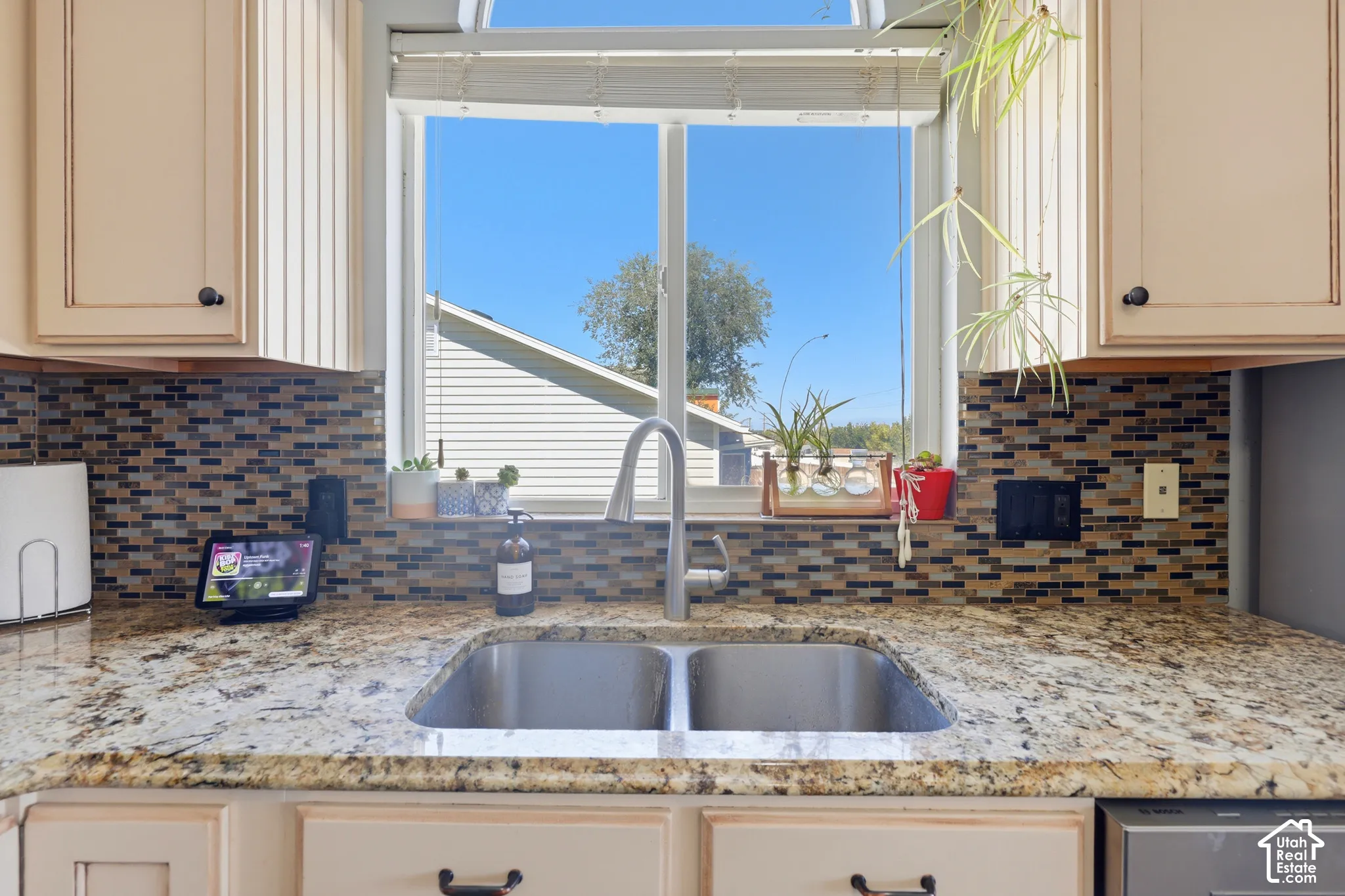 Dual basin stainless steel sink set within granite countertops