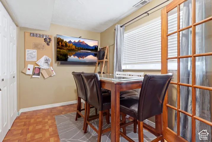 Hardwood French doors, window with blinds, wood-finish flooring, and recessed ceiling lighting