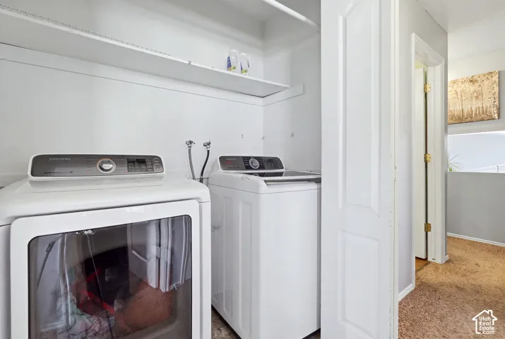 Laundry alcove featuring white shelving