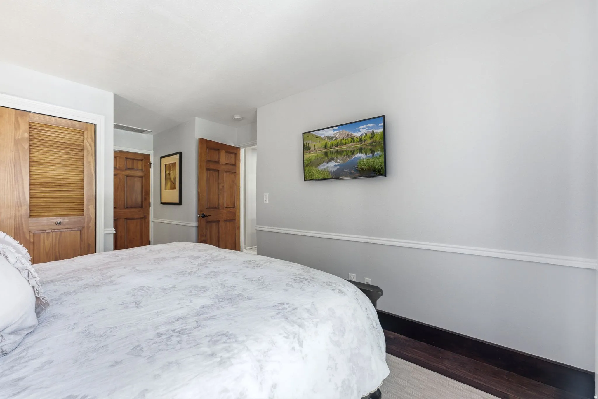Recessed lighting, wood-finish flooring, wood doors, and white crown molding