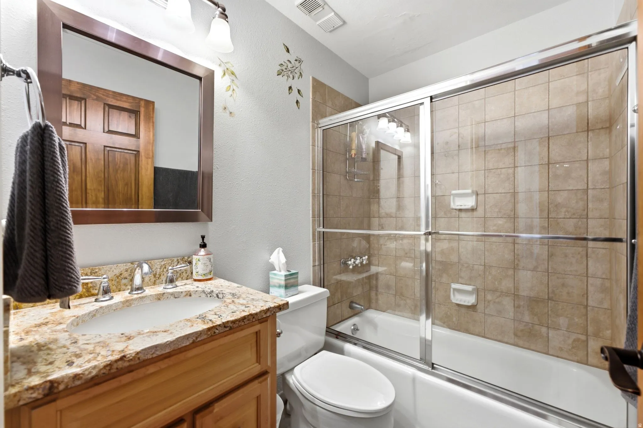 Vanity with stone countertop and integrated sink