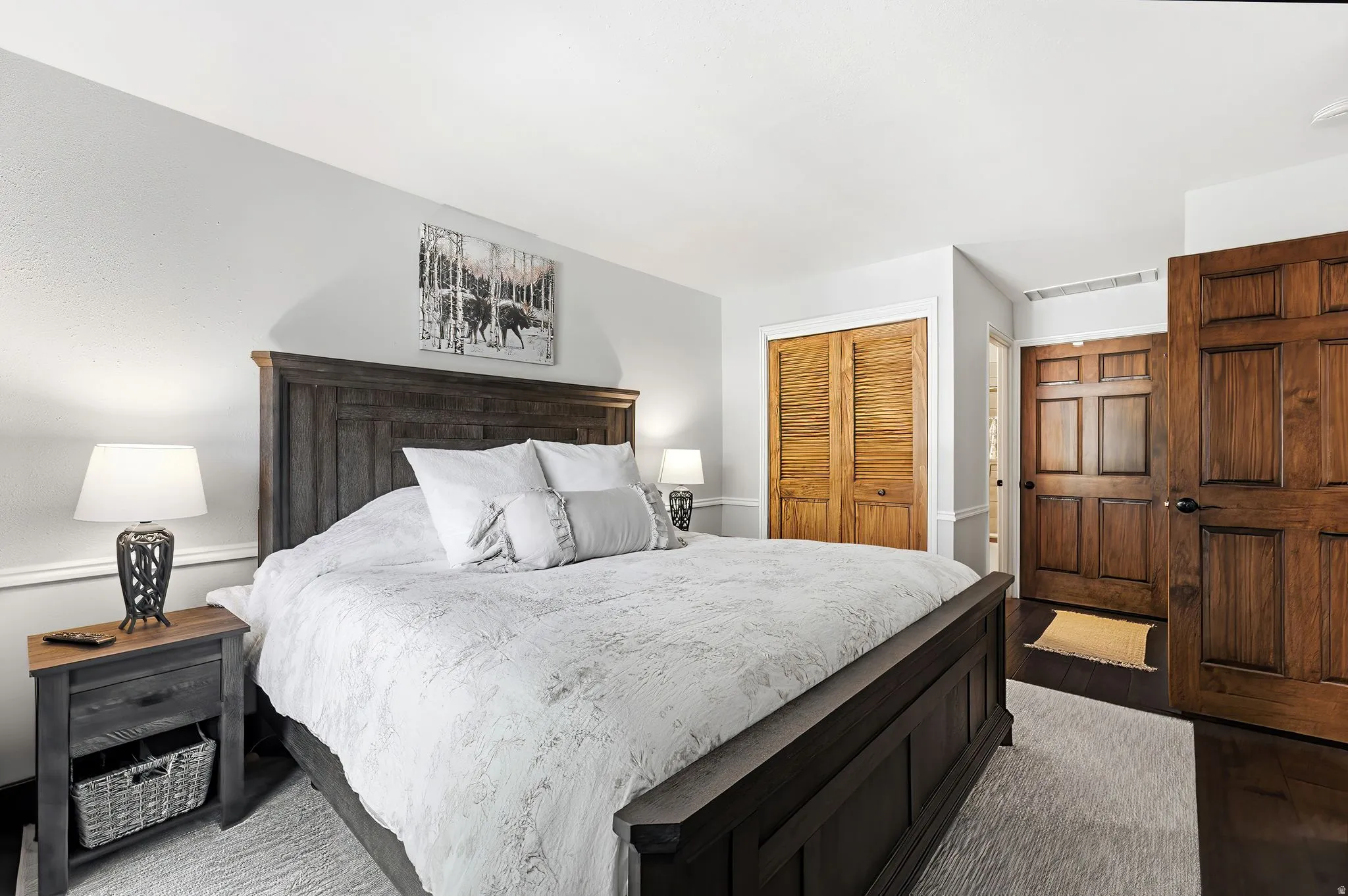 Warm wood doors, white trim, and light gray walls