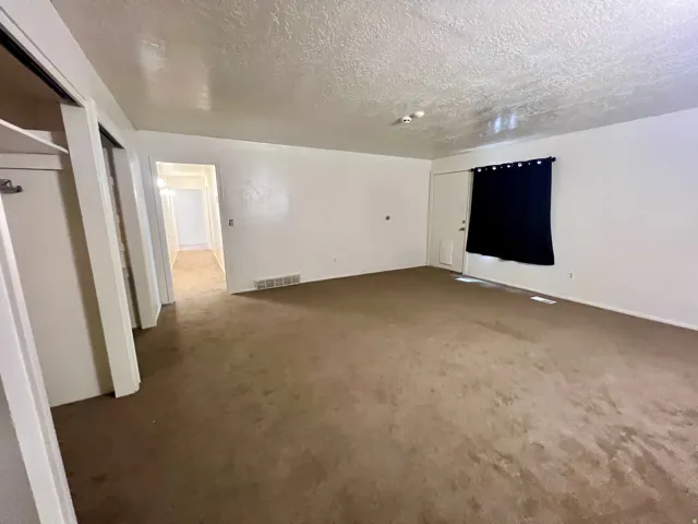 Carpeted interior with white walls and trim