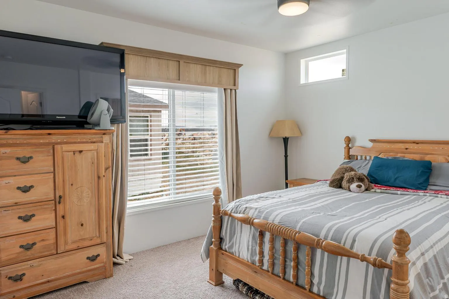 Recessed ceiling light, high-set transom window, and a large window with blinds