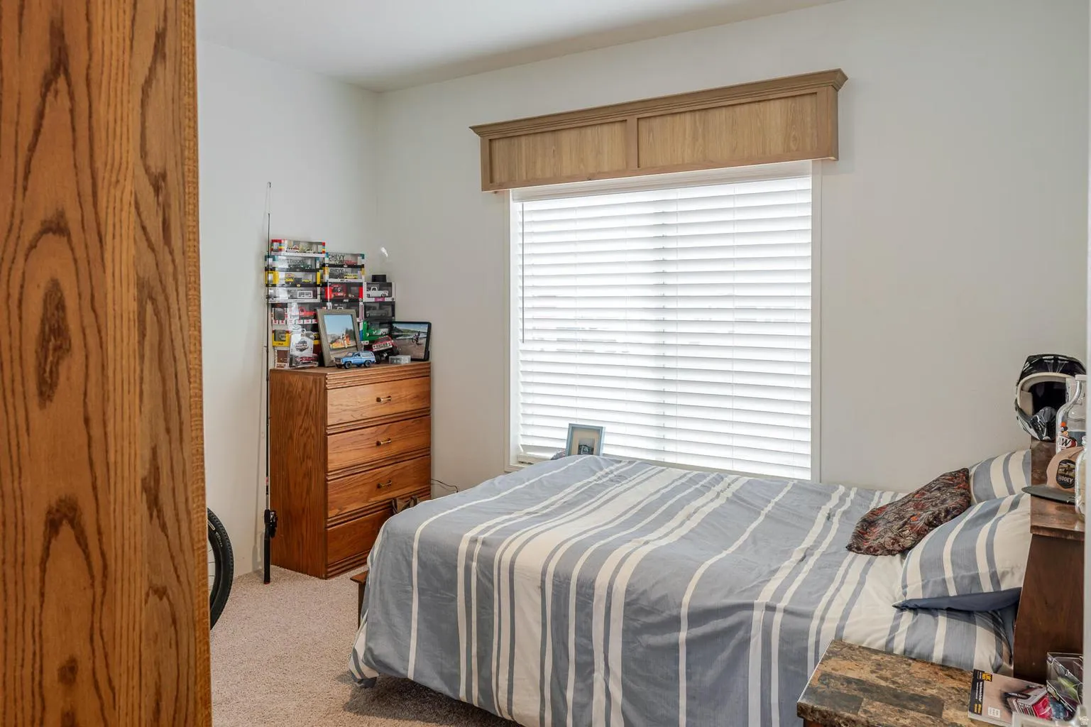 Window with horizontal blinds and a decorative wood valance