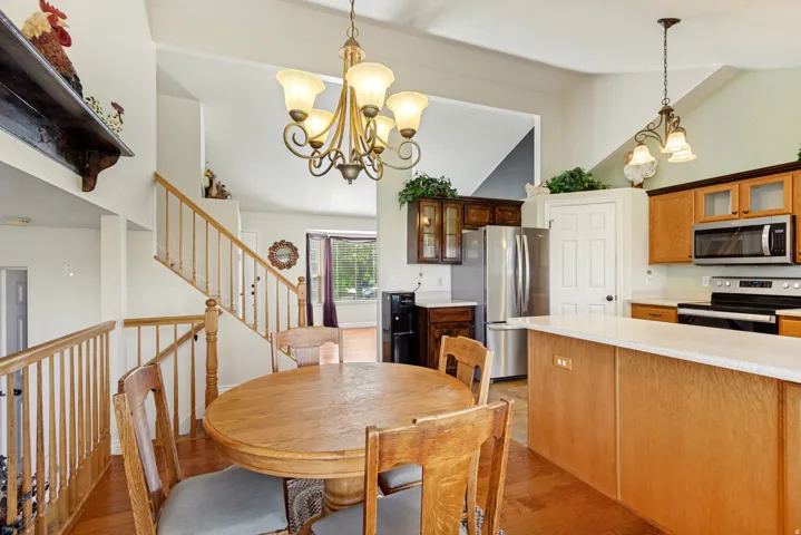 Kitchen featuring wood-finish cabinetry, stainless steel appliances, and light-toned countertops