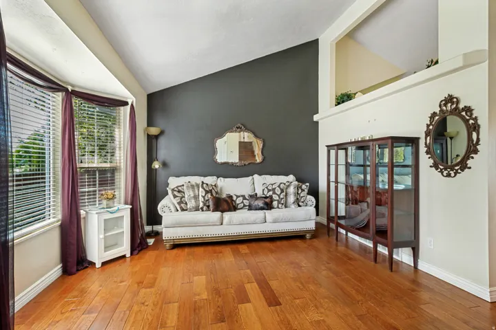 Wood-finish flooring with bay windows and vaulted ceilings