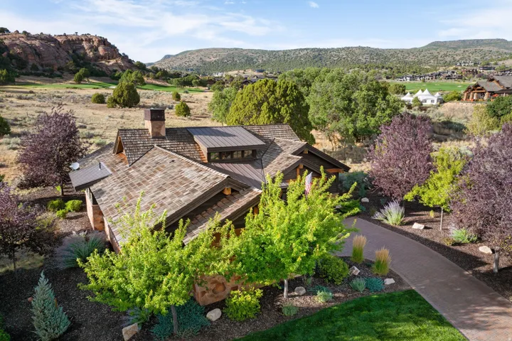 Stone-clad exterior with a cedar shake roof and metal accents