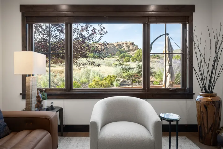 Dark wood window frames with a natural landscape backdrop