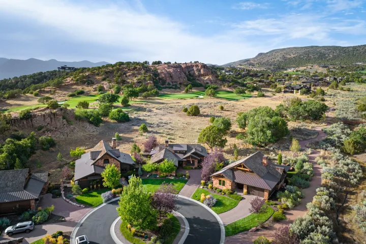 Cul-de-sac properties featuring natural wood and stone exteriors, integrated garages, and mature landscaping