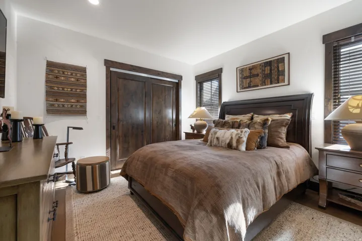 Rich wood-finish flooring with an area rug