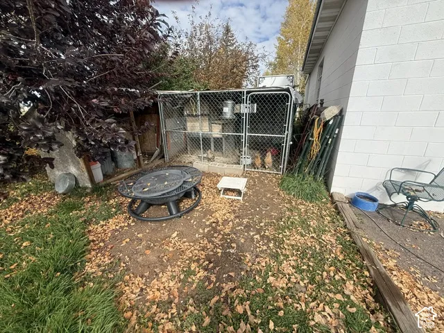 Chain-link outdoor enclosure with metal roofing and exterior concrete block wall