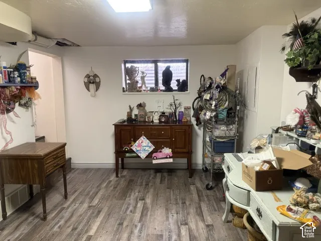 Wood-finish flooring and a rectangular window providing natural light