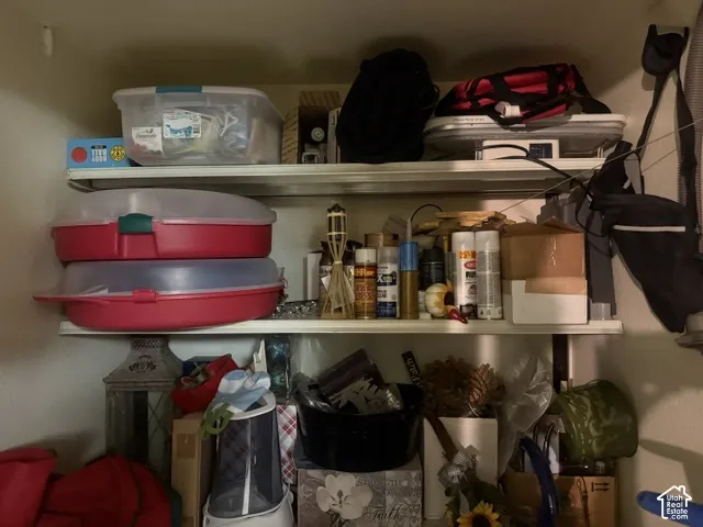 Storage space featuring three levels of fixed shelving