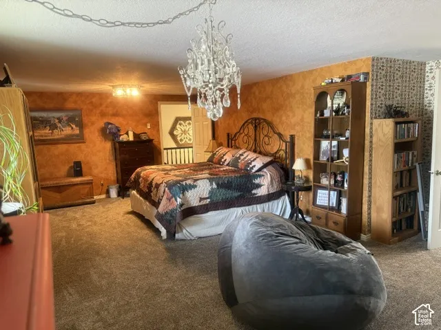 Multi-textured wall treatments, ornate crystal chandelier, and flush-mount ceiling light fixture