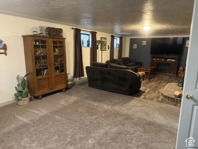 Spacious interior featuring wood-finish flooring, a stone-surround fireplace, a built-in media console, and recessed lighting