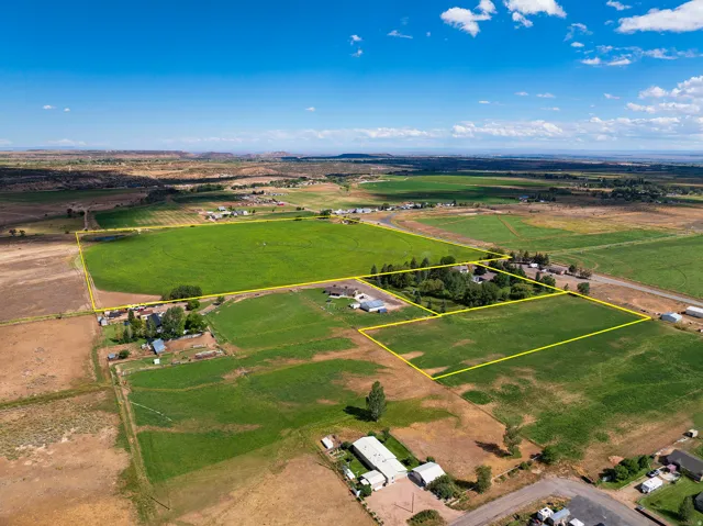 Expansive agricultural land featuring multiple parcels, cultivated fields, and mature trees