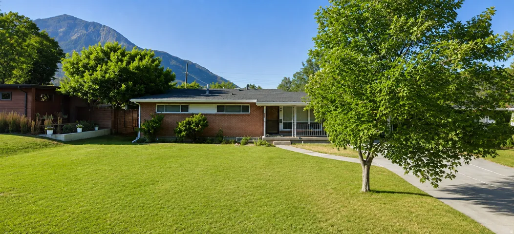 Brick exterior with a covered front porch and a paved driveway