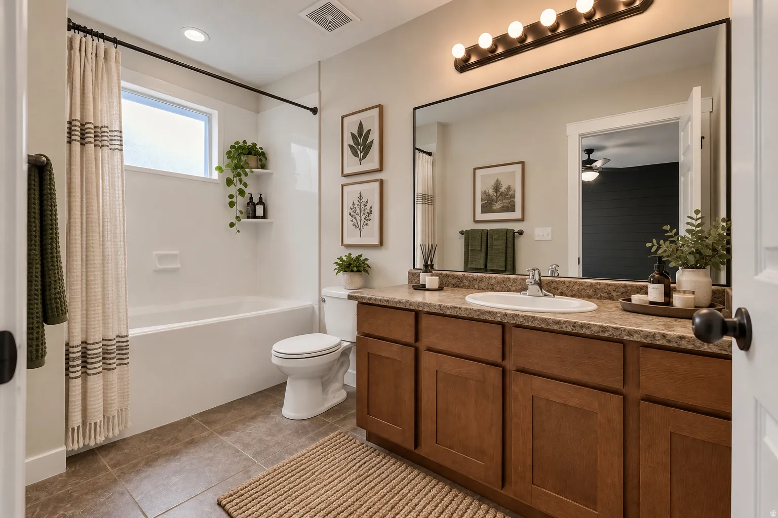 Bathroom featuring a built-in tub with white surround, single vanity with wood-finish cabinetry, integrated sink, and large framed mirror