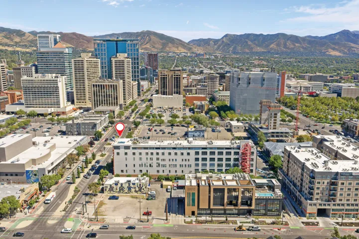 Urban development with surrounding multi-story buildings and distant mountainous terrain