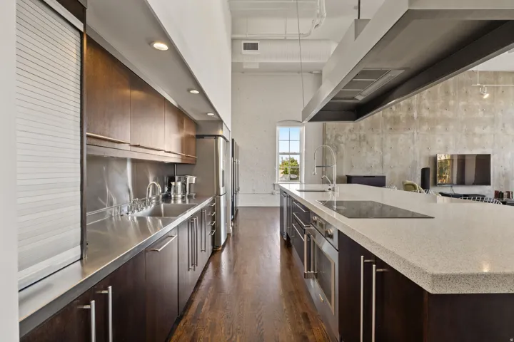 Stainless steel appliances, built-in cooktop, and an expansive island