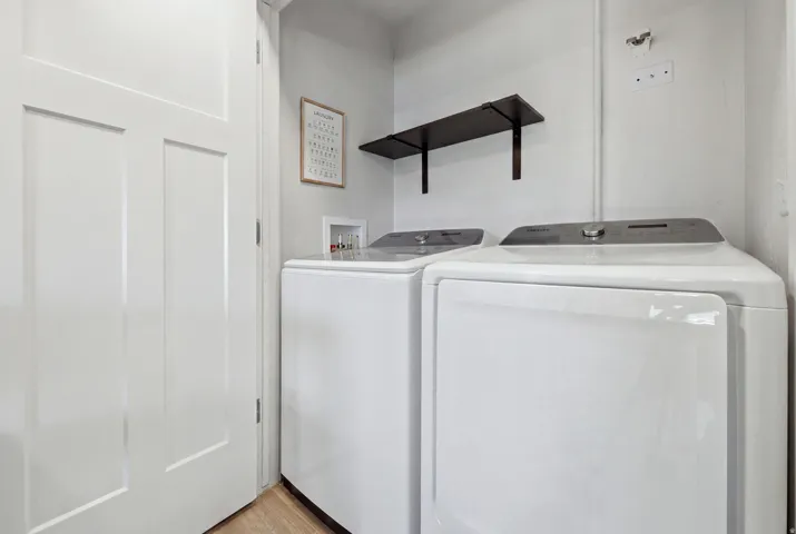 Light wood-finish flooring with white walls