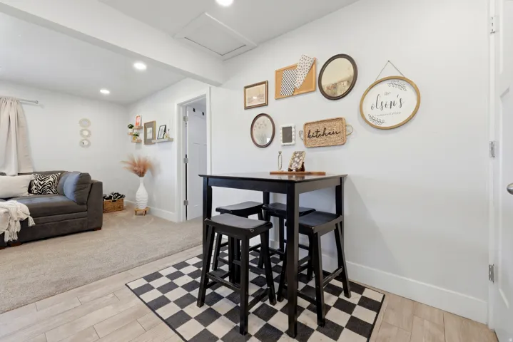 Recessed ceiling lighting, durable wood-finish flooring, and white interior doors