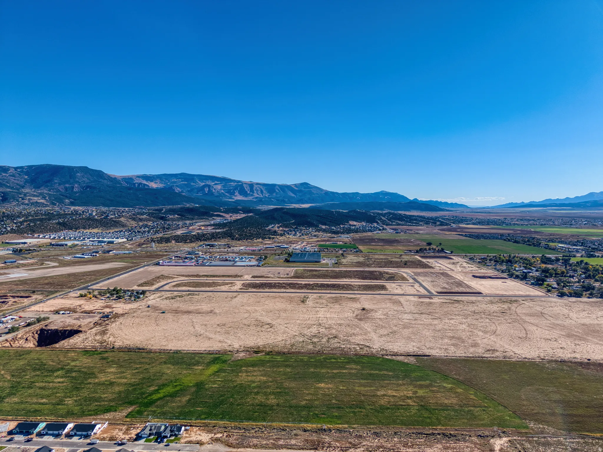 Expansive land offering development potential, surrounded by distant mountains