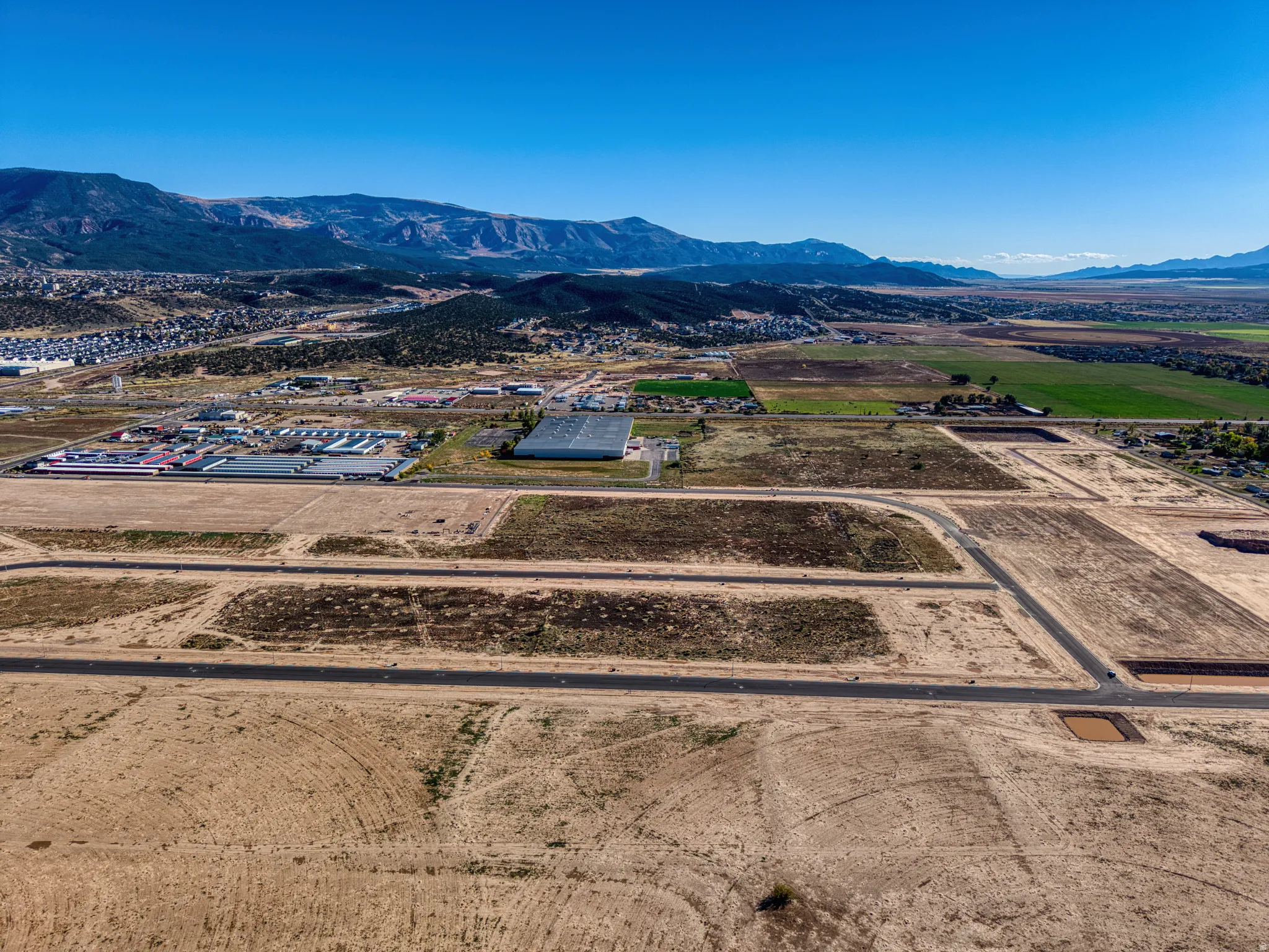 Expansive land parcel featuring graded plots and established roadway infrastructure