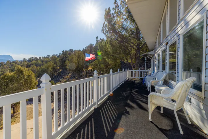 Exterior deck featuring white railing and siding