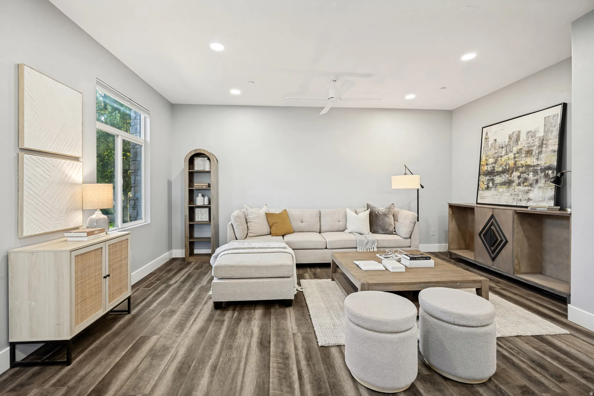 Recessed lighting, ceiling fan, wood-finish flooring, white trim, and a window with exterior visibility