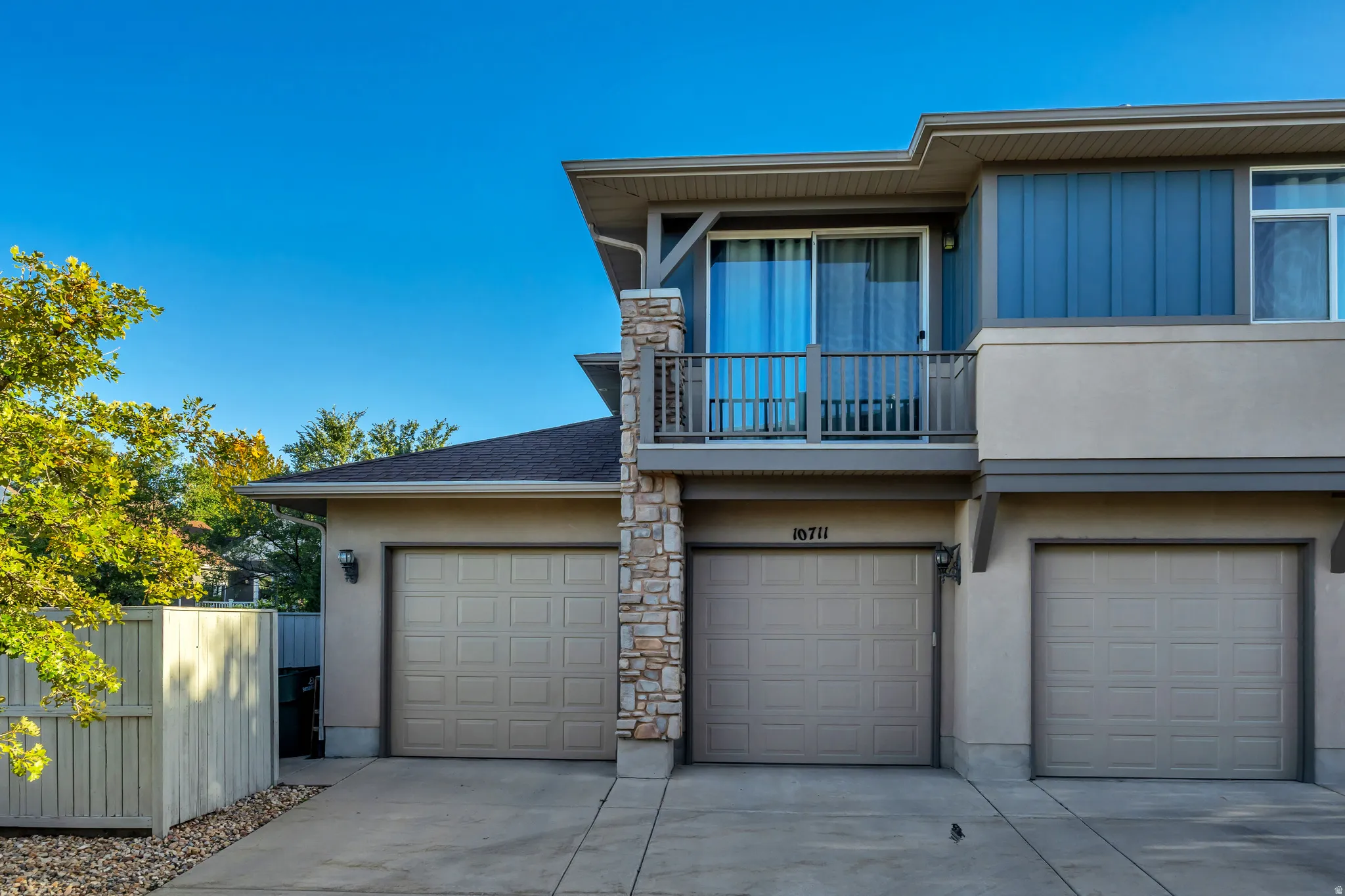 Stucco exterior with stone accents and a private balcony