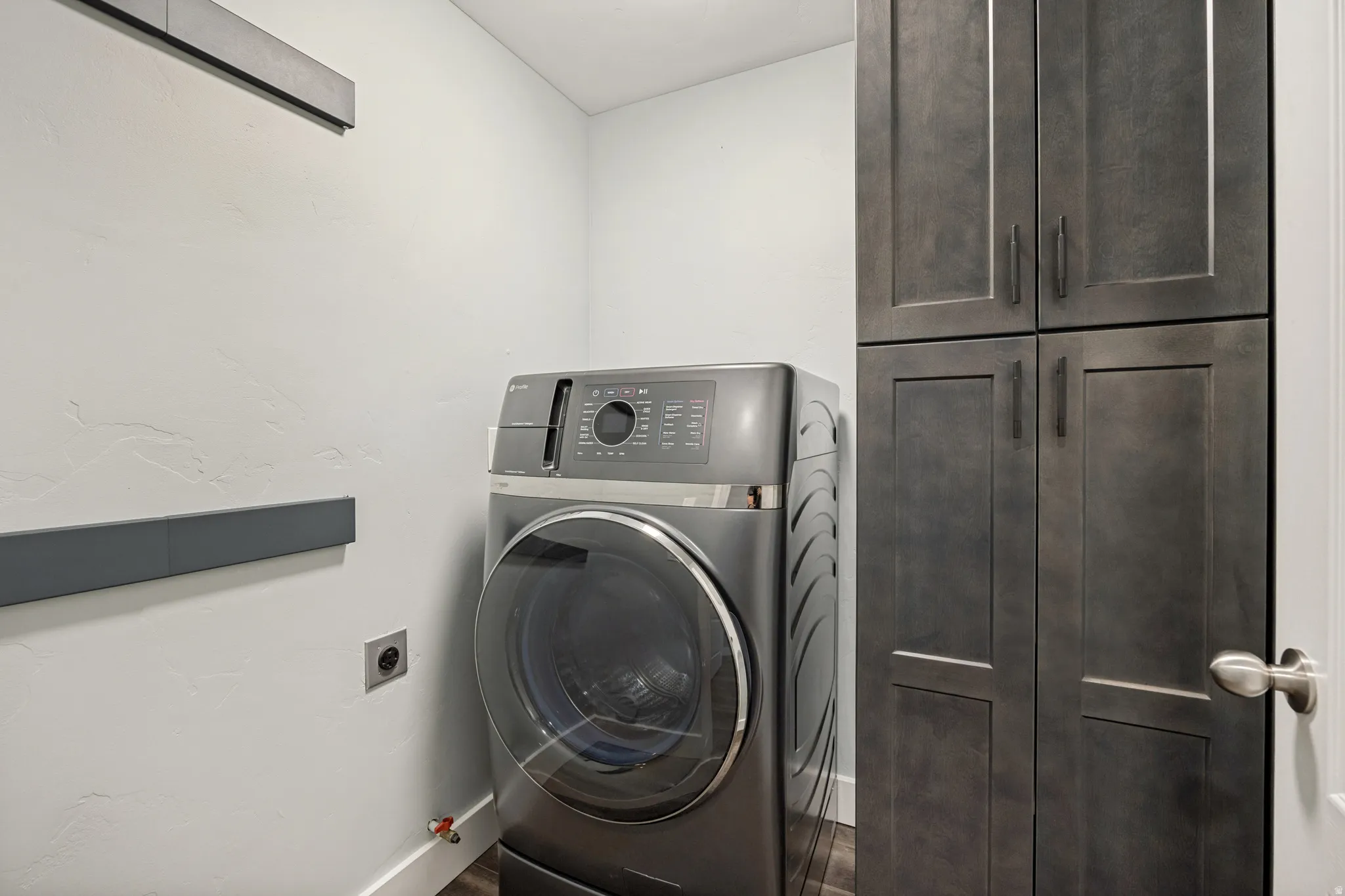 Built-in cabinetry with dark wood-finish doors and matte black hardware