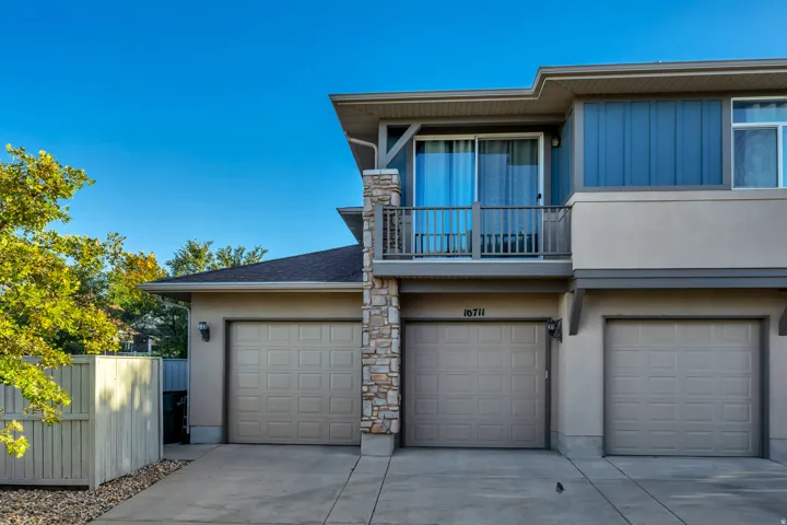 Stucco exterior with stone accents and a private balcony