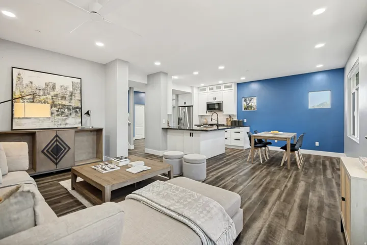 Open-concept living area with wood-finish flooring, recessed lighting, and a contemporary ceiling fan