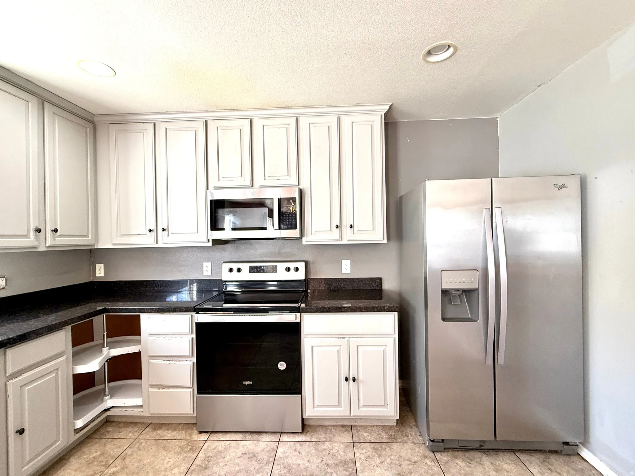 White cabinetry with dark contrasting countertops