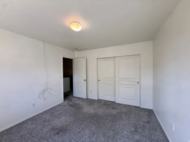 Plush gray carpeting and white walls