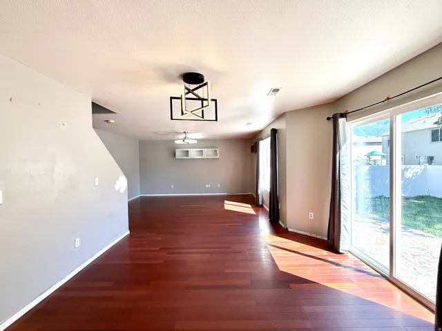 Wood-finish flooring throughout, complemented by a modern ceiling light fixture