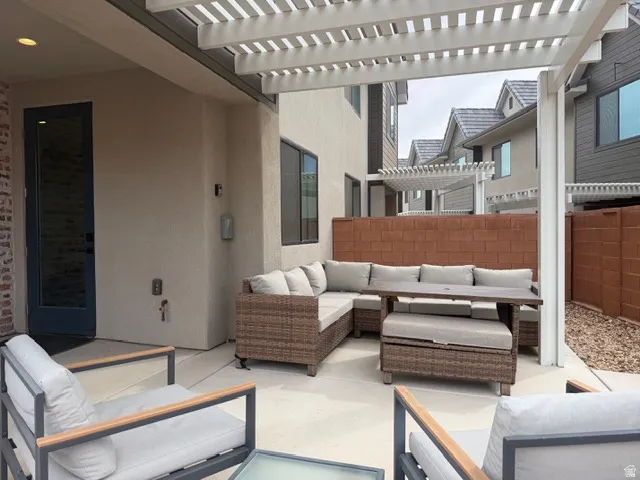 Covered outdoor patio with a white slatted pergola
