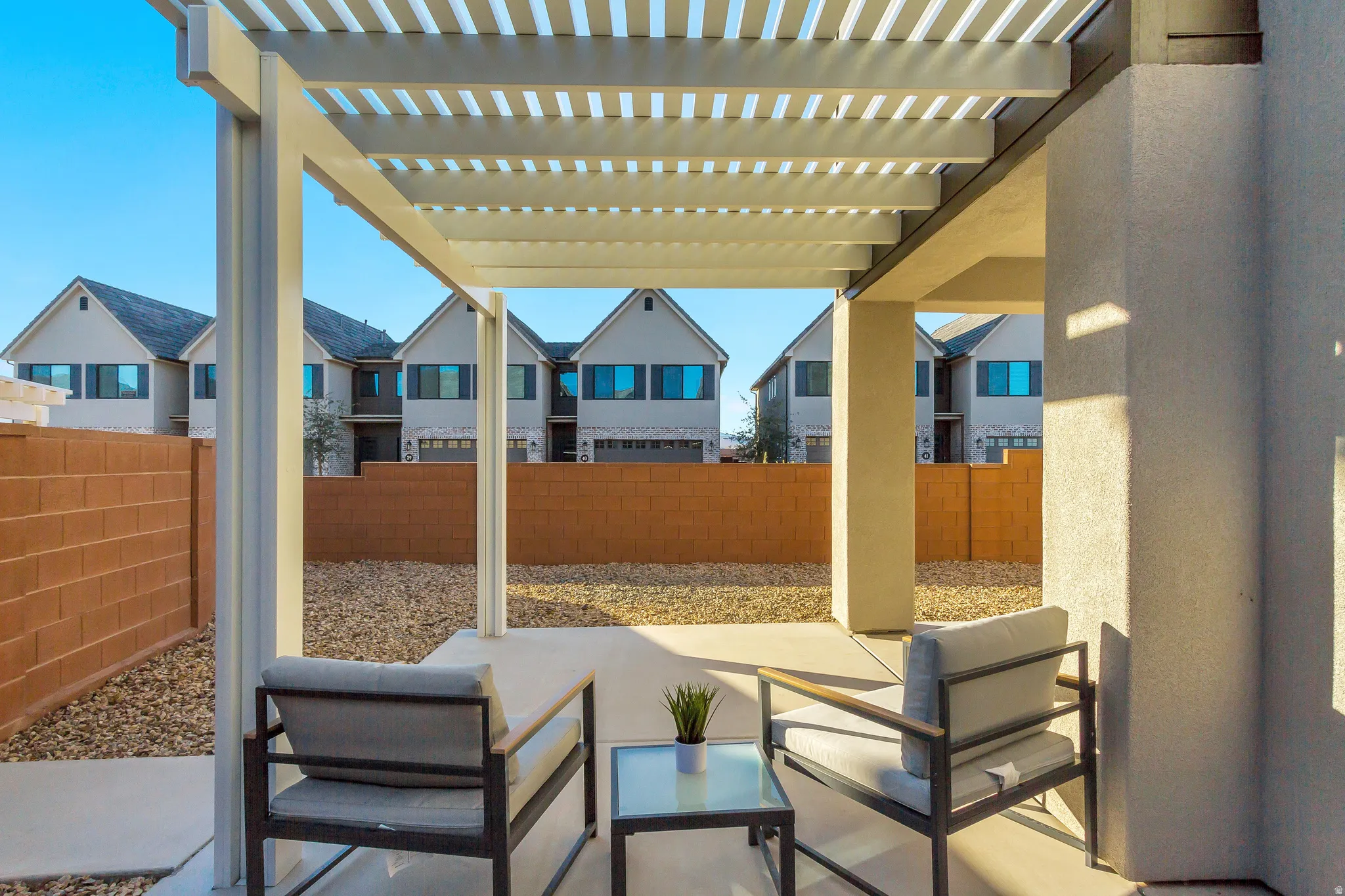 Covered patio featuring a slat pergola and concrete flooring