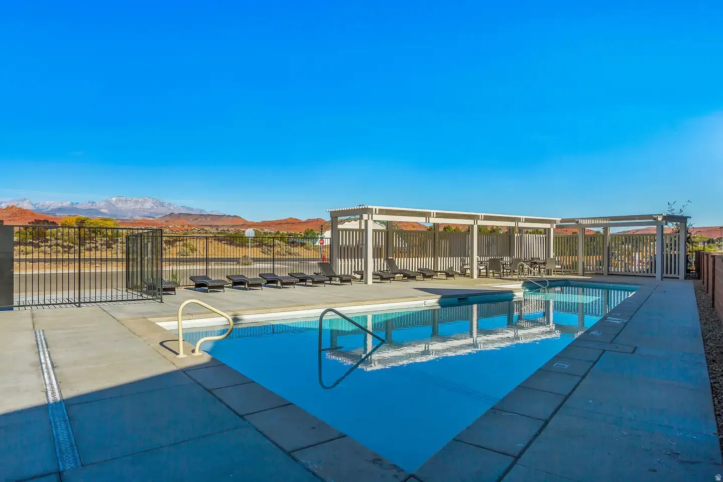 Rectangular swimming pool with integrated steps, surrounded by a concrete deck