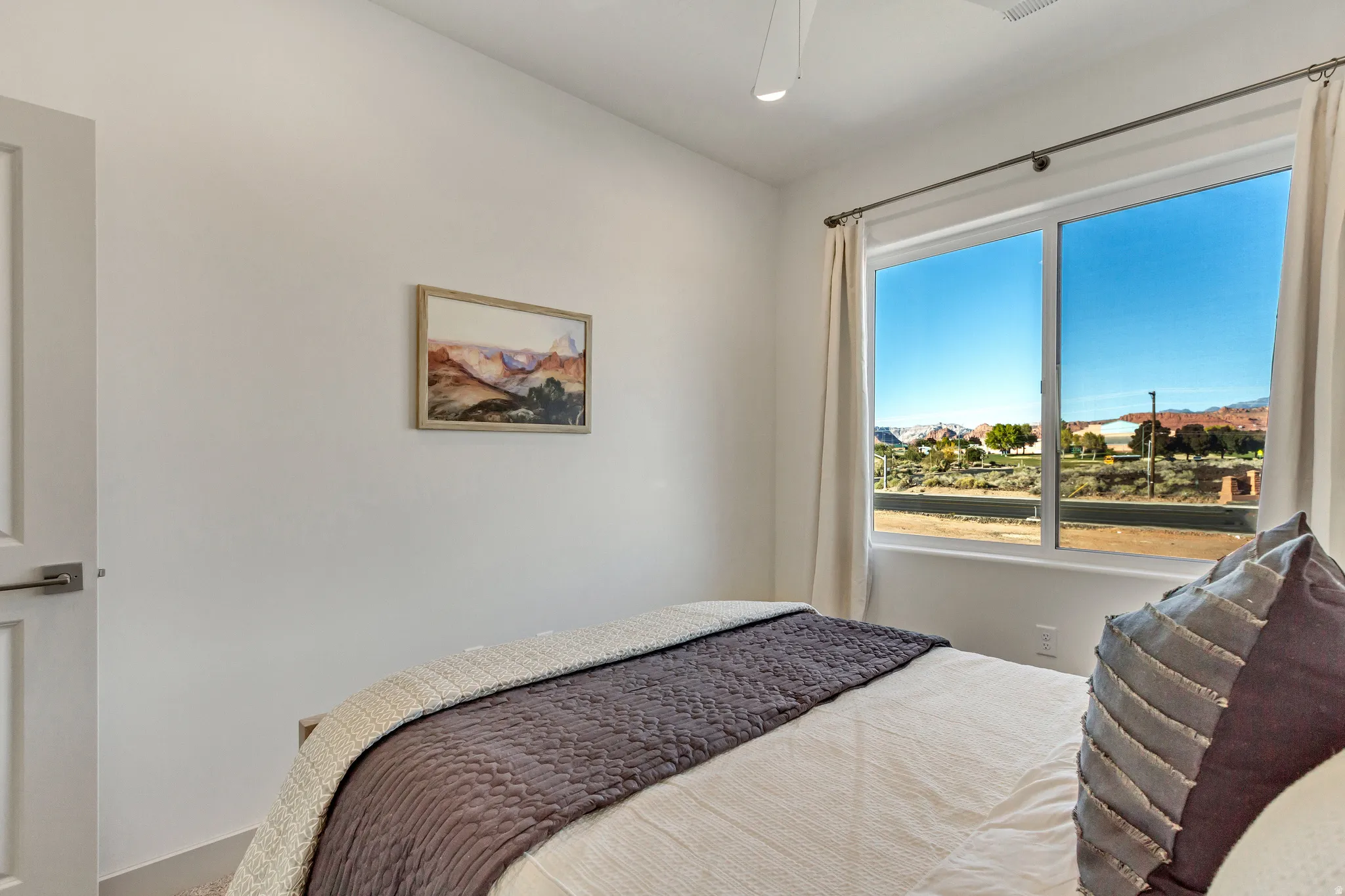 Large sliding window with a mountain backdrop and surrounding terrain