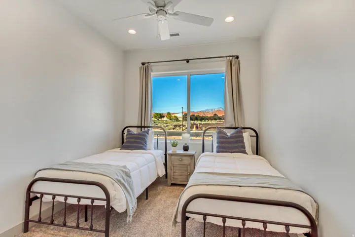 Recessed lighting, ceiling fan, and large window with natural light