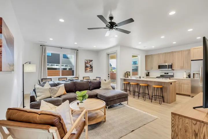 Open-concept living space featuring wood-finish flooring, recessed lighting, and a ceiling fan