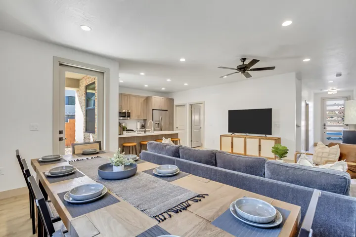 Open concept design featuring recessed lighting, a modern kitchen with stainless steel appliances, and wood-finish flooring