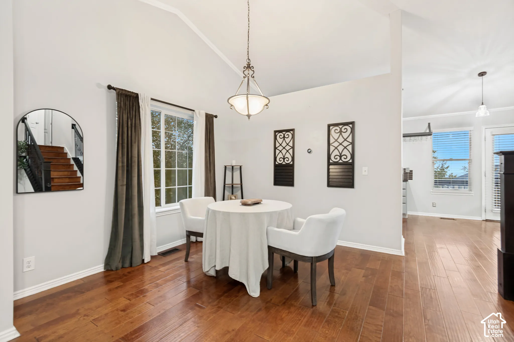 Vaulted ceilings, wood-finish flooring, and a metal lantern-style chandelier