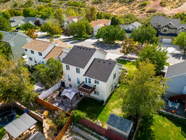 Two-story property featuring a pitched roof, rear deck, and a fenced backyard with a gazebo