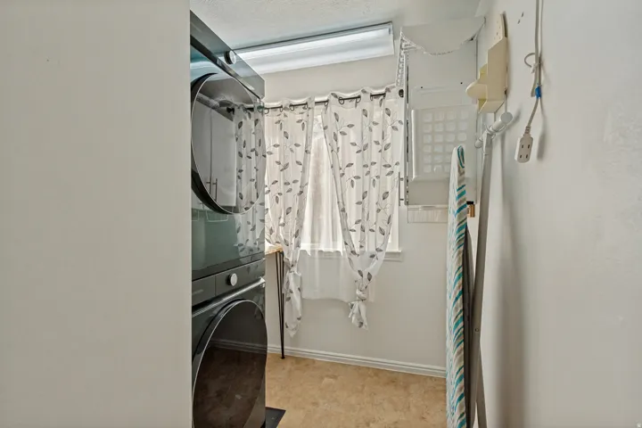 Stackable laundry appliances and a window with natural light
