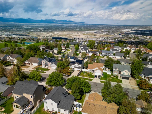 Residential neighborhood with a mountain backdrop, mature trees, and varied architectural styles