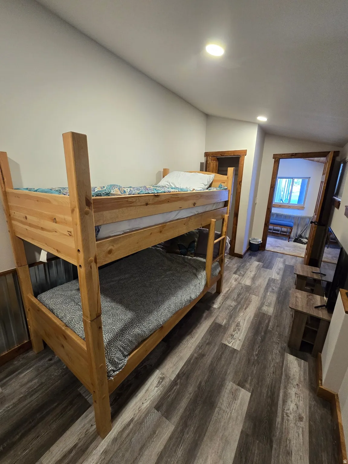 Wood-finish flooring, recessed ceiling lights, and wood-framed doorways